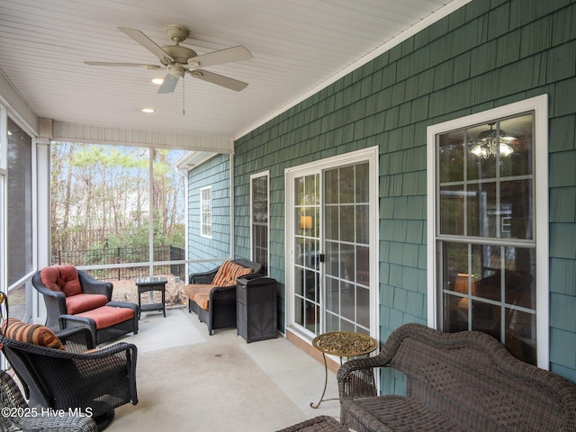 sunroom featuring a ceiling fan