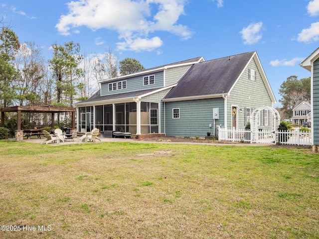 rear view of property with a patio area, fence, a lawn, and a sunroom