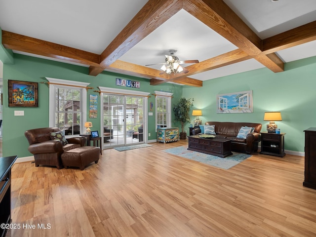 living area with beam ceiling, baseboards, a ceiling fan, and wood finished floors