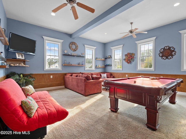 playroom with wainscoting, wood walls, and a ceiling fan