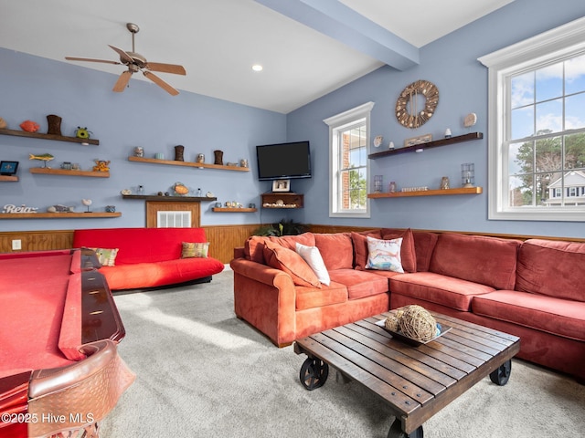 carpeted living room featuring beam ceiling and a ceiling fan