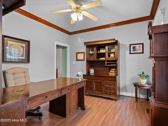 office area with ceiling fan, baseboards, light wood-type flooring, and ornamental molding