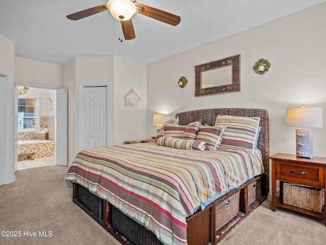 bedroom featuring a closet, ceiling fan, ensuite bathroom, and carpet