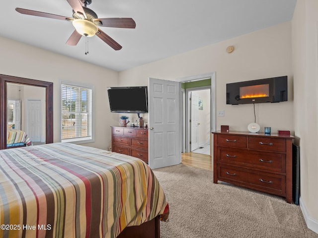 bedroom featuring light colored carpet and ceiling fan