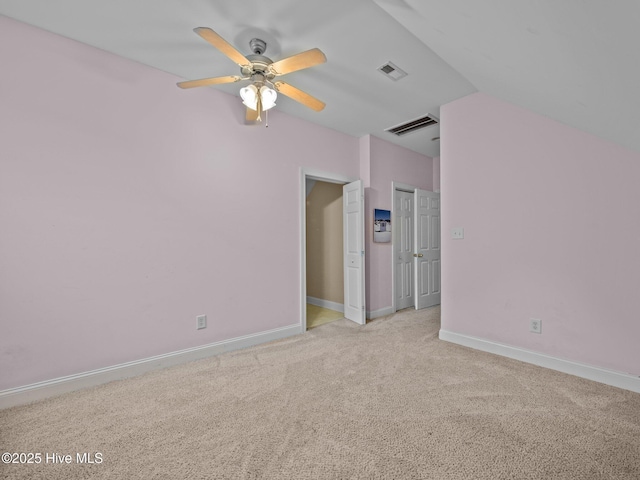 empty room with visible vents, light carpet, baseboards, and a ceiling fan