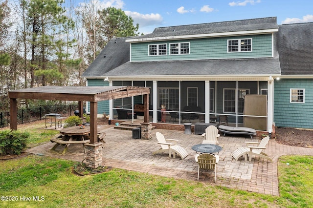 rear view of property featuring a patio, fence, a pergola, and a sunroom