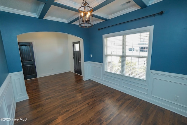 foyer featuring visible vents, coffered ceiling, arched walkways, dark wood-type flooring, and beam ceiling