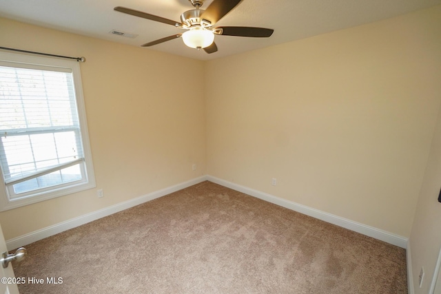 unfurnished room featuring a ceiling fan, carpet flooring, visible vents, and baseboards