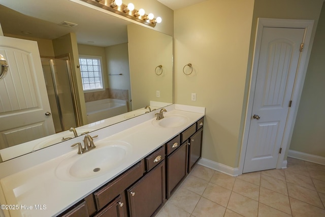 full bath with a stall shower, a sink, a bath, and tile patterned floors