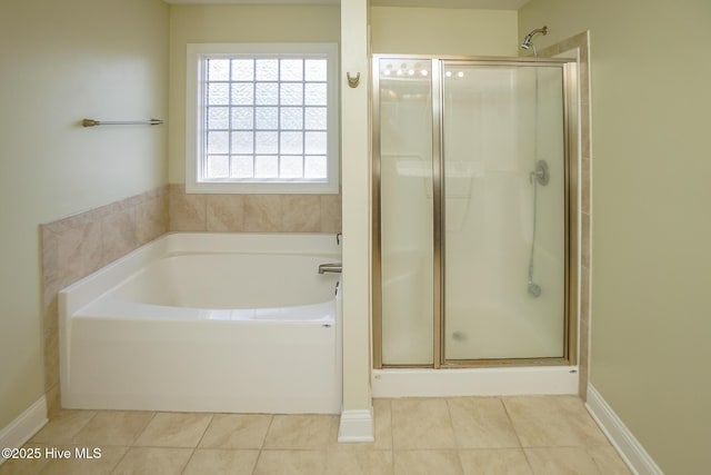 bathroom featuring a shower stall, a bath, and tile patterned floors