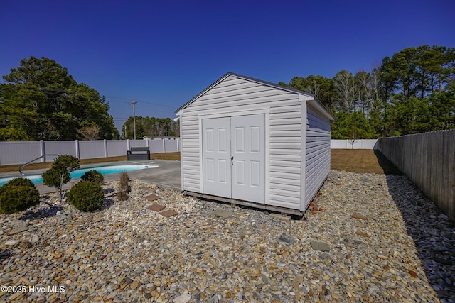 view of shed featuring a fenced backyard and a fenced in pool