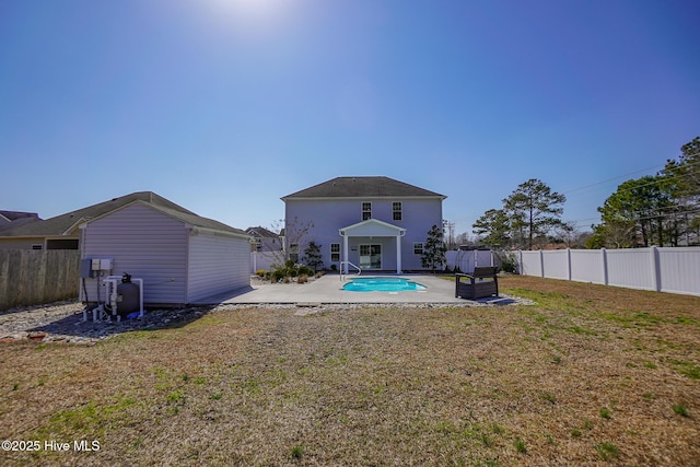 back of property with a fenced in pool, a patio area, a yard, and a fenced backyard