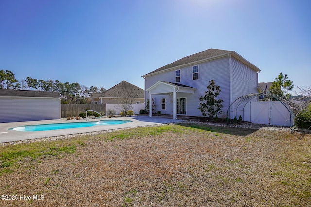 view of pool with a patio area, a fenced backyard, a fenced in pool, and an outbuilding