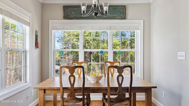 dining space with a chandelier and baseboards