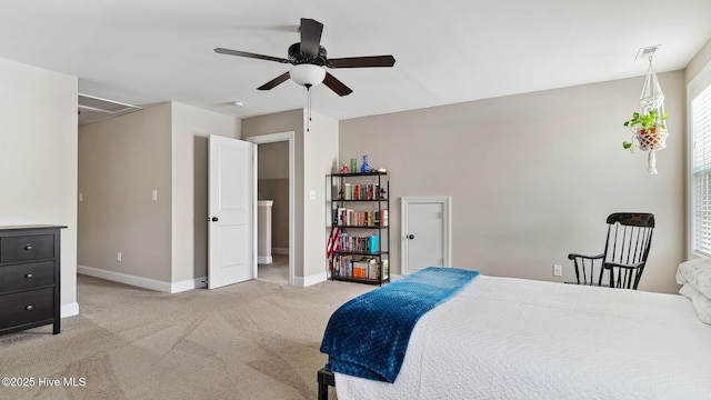 bedroom with attic access, light carpet, baseboards, and a ceiling fan