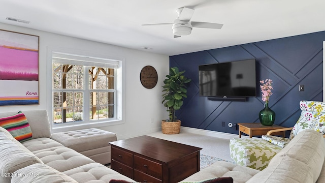 carpeted living area with ceiling fan, visible vents, and baseboards