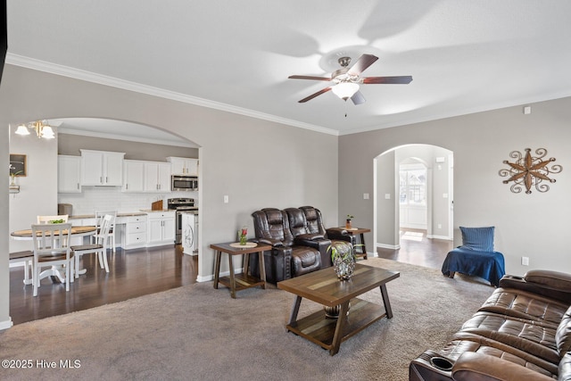 living area with baseboards, arched walkways, ceiling fan, crown molding, and dark colored carpet