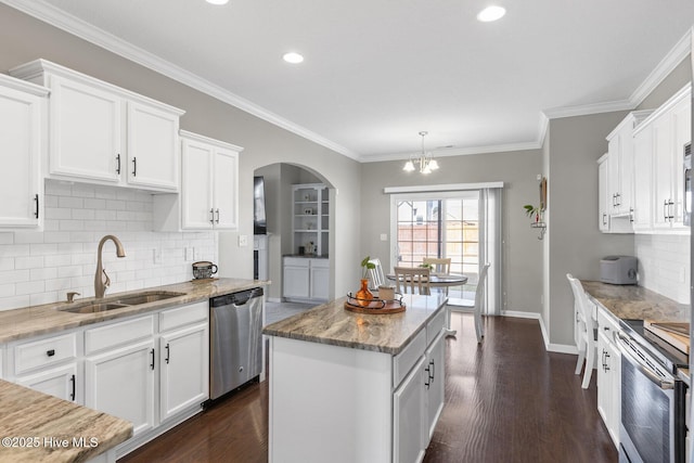 kitchen with a sink, a kitchen island, dark wood finished floors, white cabinetry, and stainless steel appliances