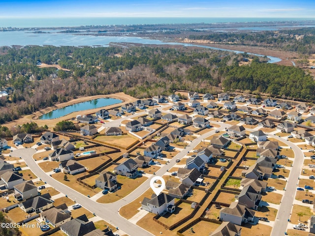 bird's eye view with a forest view, a water view, and a residential view