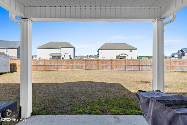 view of yard featuring a residential view and a fenced backyard