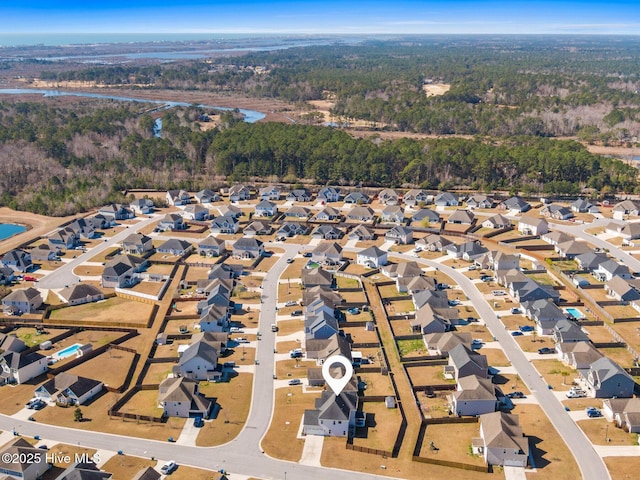 birds eye view of property featuring a view of trees and a residential view