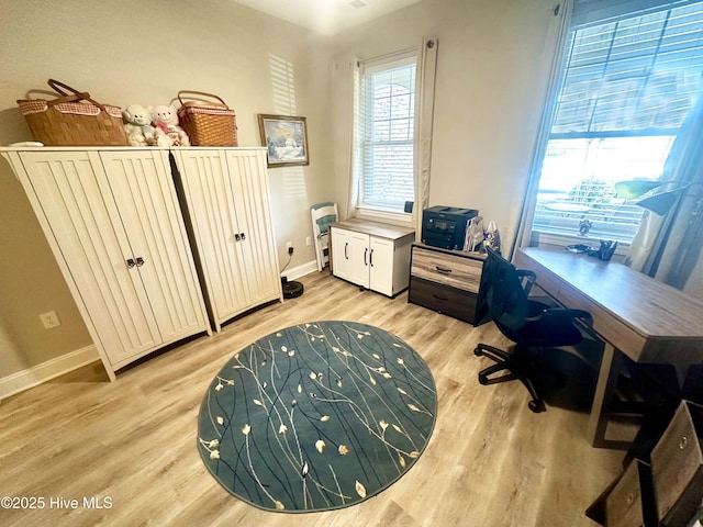 home office featuring light wood-type flooring and baseboards