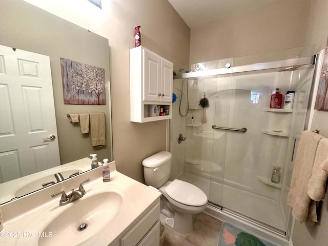 full bathroom featuring a stall shower, tile patterned flooring, vanity, and toilet