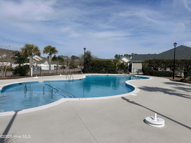 pool featuring a patio and fence