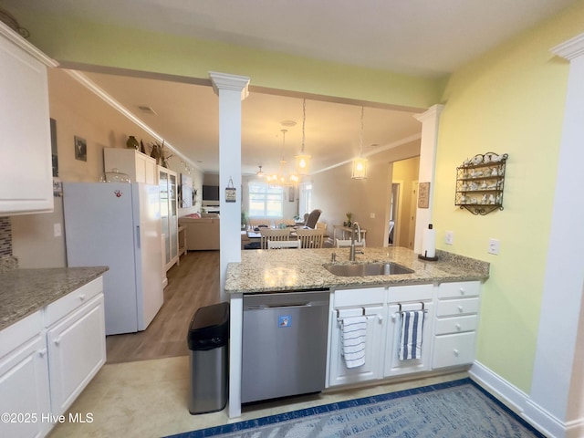 kitchen with ornate columns, a sink, freestanding refrigerator, dishwasher, and crown molding