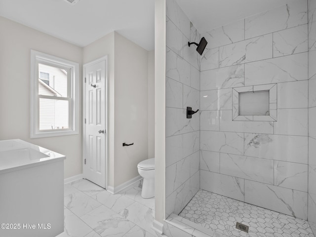 full bathroom with a stall shower, marble finish floor, toilet, and baseboards