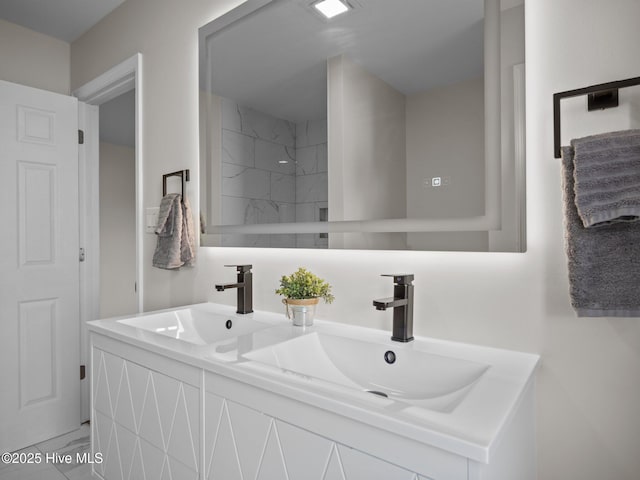 bathroom with a shower, marble finish floor, a sink, and double vanity