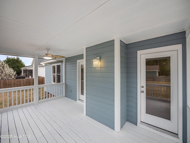 wooden deck featuring ceiling fan