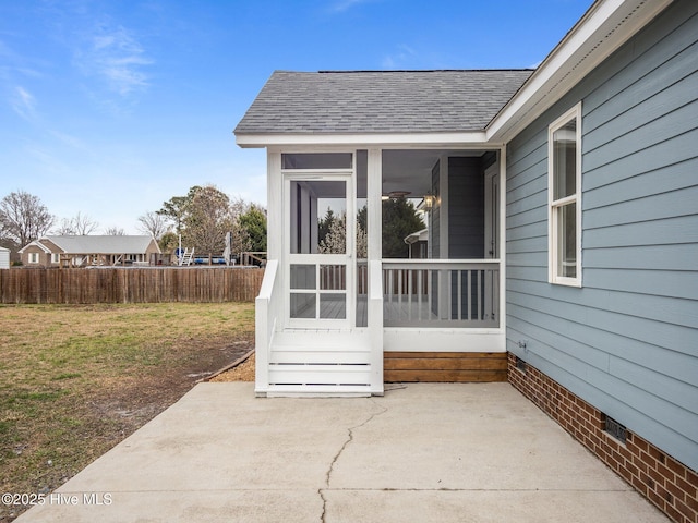 doorway to property with a patio, a shingled roof, fence, a yard, and crawl space