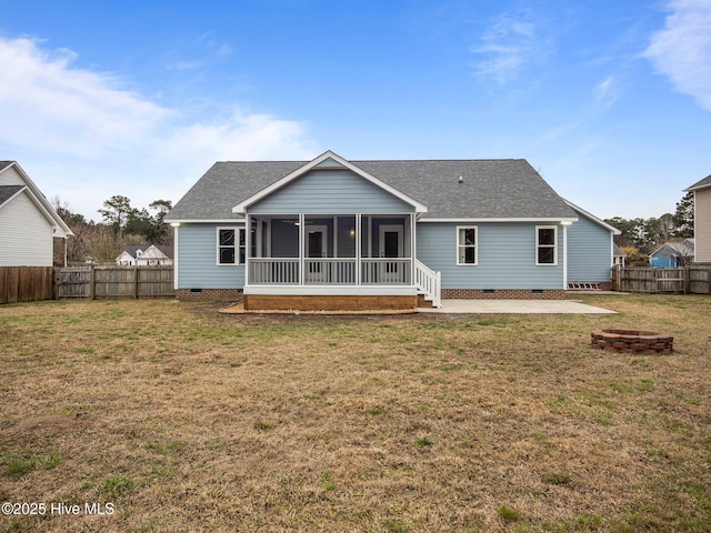 back of house featuring a sunroom, crawl space, a fenced backyard, and a yard