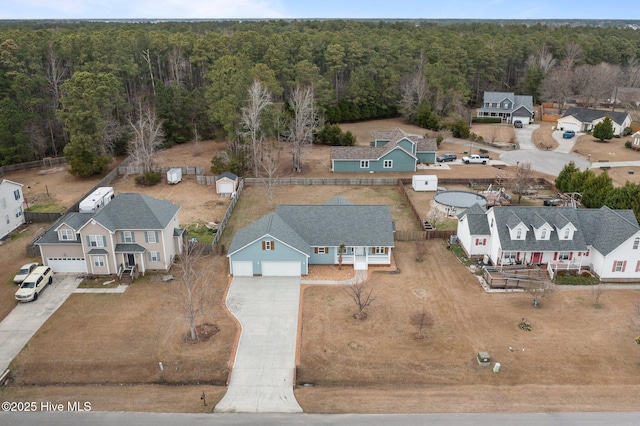 aerial view featuring a residential view and a wooded view