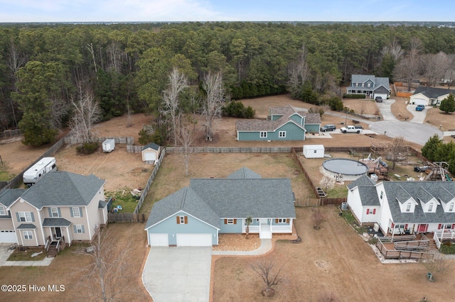 aerial view featuring a forest view and a residential view