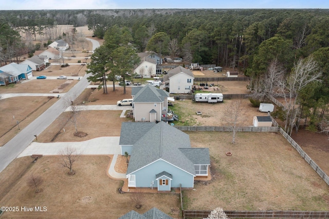 drone / aerial view featuring a forest view