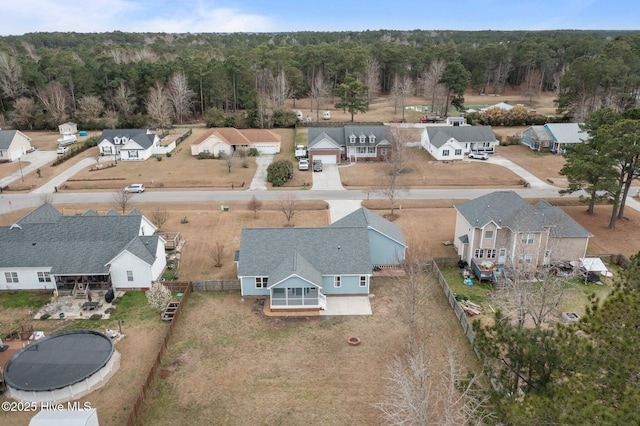 birds eye view of property featuring a forest view and a residential view