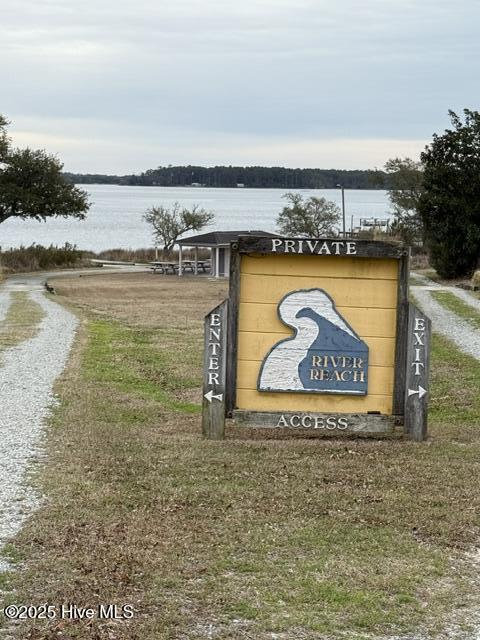 community sign featuring a water view