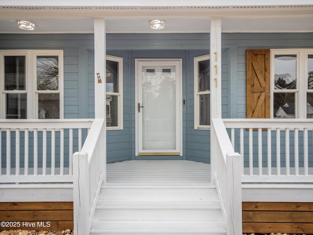 doorway to property featuring covered porch