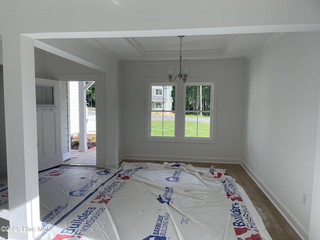 516 Belcroft Dr, Carthage, NC 28327 - unfurnished dining area with a chandelier, ornamental molding, wood finished floors, a raised ceiling, and baseboards