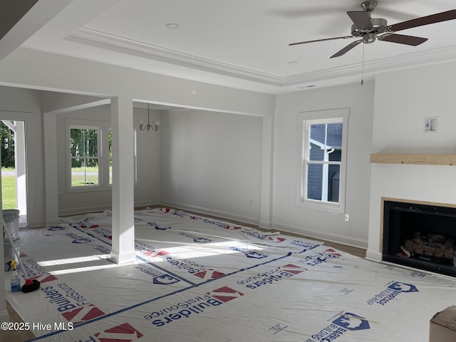 516 Belcroft Dr, Carthage, NC 28327 - living room featuring a raised ceiling, a ceiling fan, a fireplace, and a chandelier