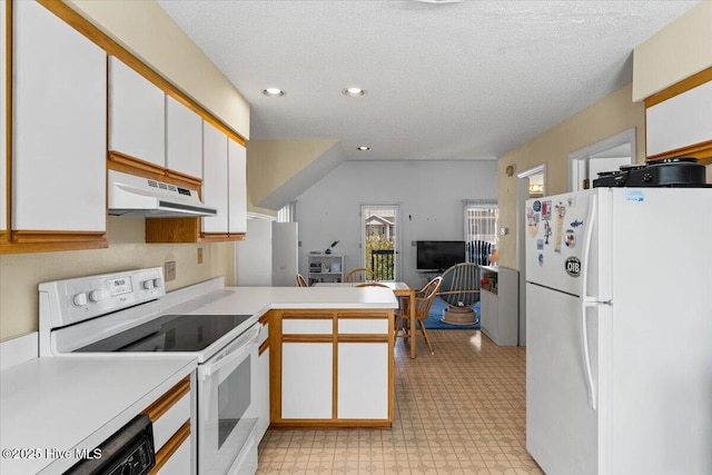 kitchen featuring under cabinet range hood, light countertops, a peninsula, white appliances, and white cabinetry