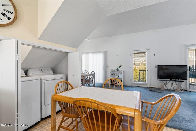 dining area featuring light carpet, washing machine and dryer, and lofted ceiling