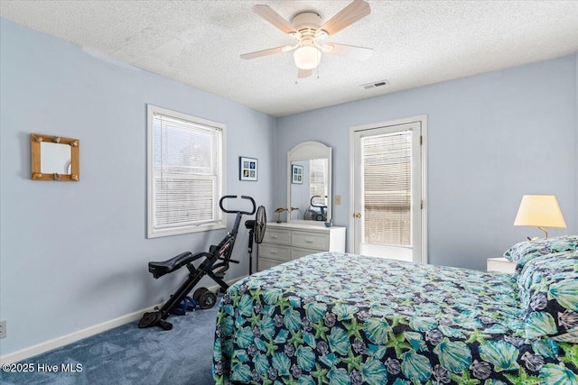 bedroom featuring carpet flooring, a textured ceiling, a ceiling fan, baseboards, and visible vents