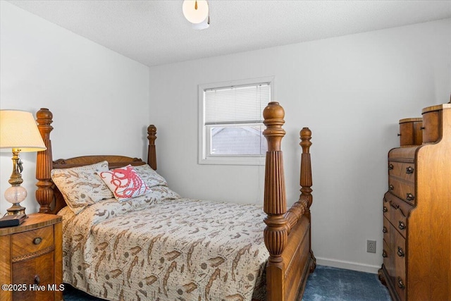 bedroom with carpet, baseboards, and a textured ceiling