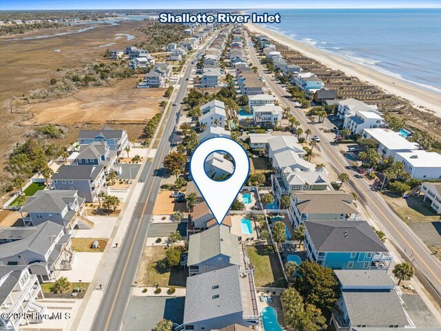 drone / aerial view with a residential view, a beach view, and a water view