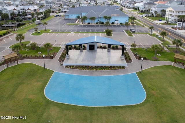 view of pool with a yard and a residential view