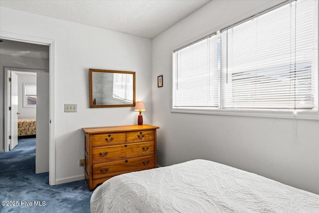 carpeted bedroom featuring a textured ceiling, multiple windows, and baseboards