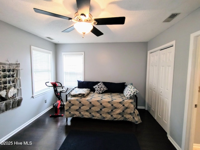 bedroom with a closet, visible vents, and baseboards